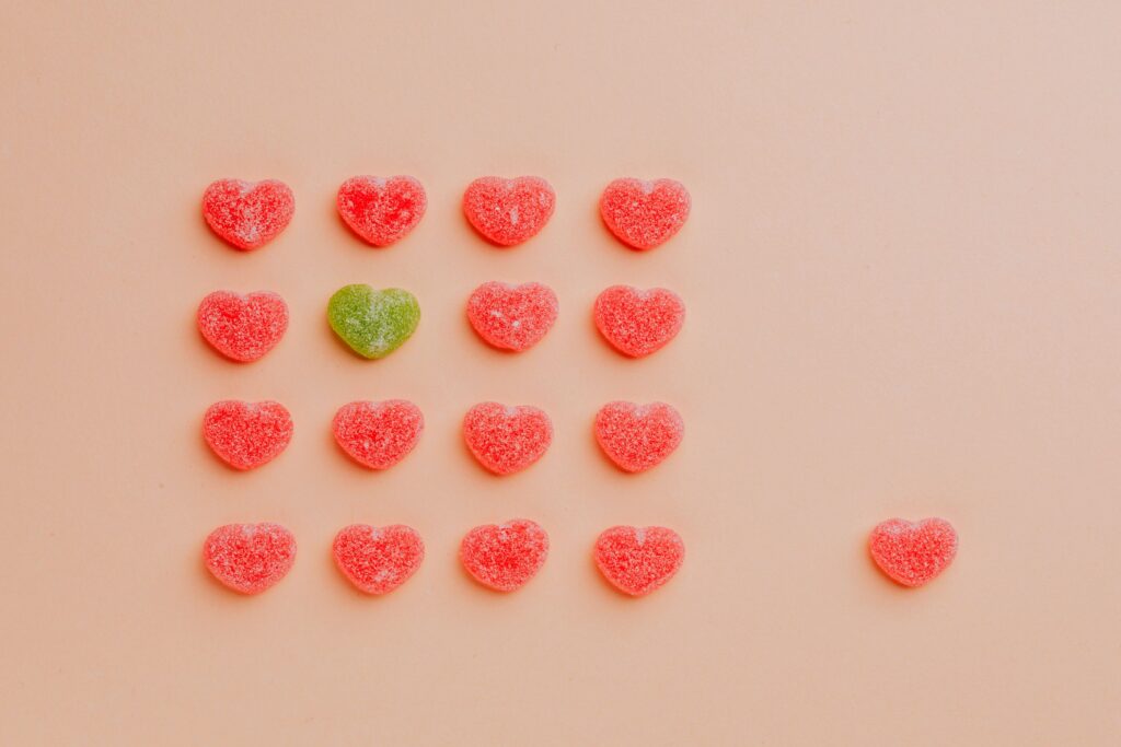 Jelly heart sweets against a peach-coloured background 